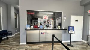 Customer exchanging currency at a counter in Hialeah